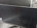a computer monitor sitting on top of a desk next to a keyboard and mouse