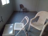 a white chair and a white chair in a room