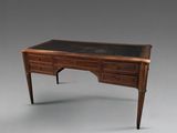 an image of a desk with a black top and wooden legs