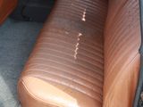 a brown leather seat in the back of a car