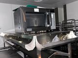 a kitchen with stainless steel counter tops and a microwave