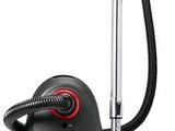 a black vacuum cleaner with a red handle on a white background