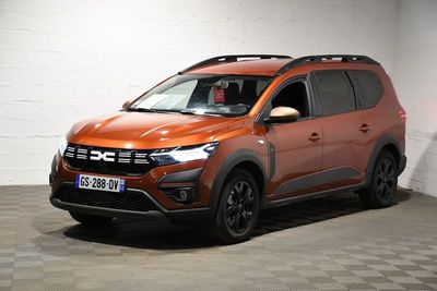 the orange car is parked in a garage with a checkered floor