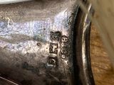 a close up of a silver spoon with a tooth brush