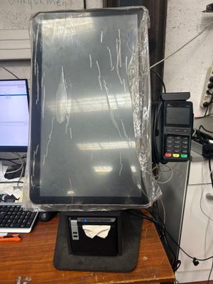 a computer monitor sitting on top of a desk covered in plastic