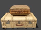 two pieces of luggage sitting on top of each other