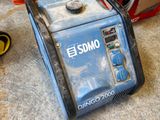 a blue and black generator sitting on the floor