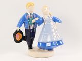 a figurine of a man and a woman holding a vinyl record