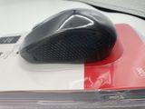 a black computer mouse sitting on top of a book
