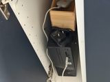a computer that is sitting on a shelf in a closet