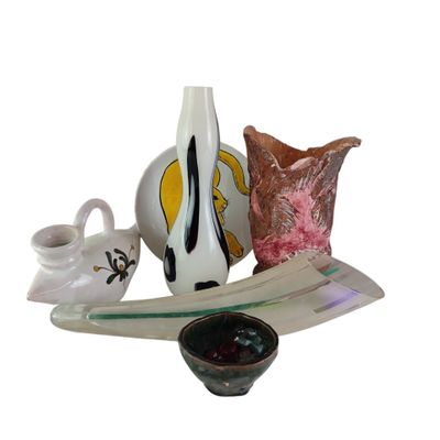 a glass plate with a vase and a bowl on it