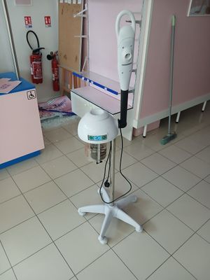 a hair dryer that is on a stand in a room
