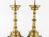 a pair of brass candlesticks with spikes on each end