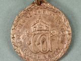 an image of a gold medal with a red ribbon around it