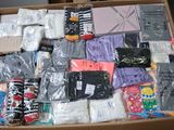 a cardboard box filled with many different types of clothing
