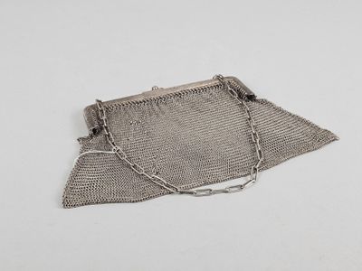 an old silver mesh purse with a chain around it