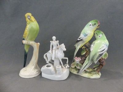 three figurines of birds sitting on top of each other