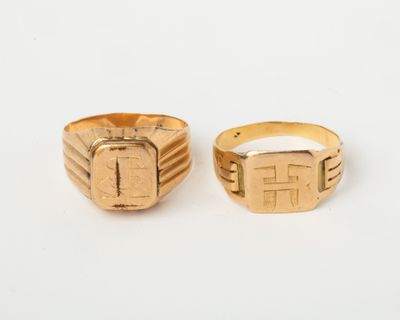 two gold rings, one with a cross and the other with a square design