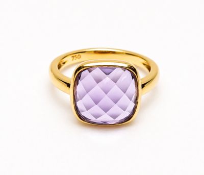 a close up of a gold ring with an amethorate stone