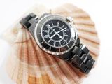 a picture of a watch sitting on a seashell