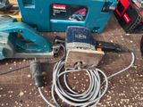 a blue machine with a cord attached to it sitting on a table