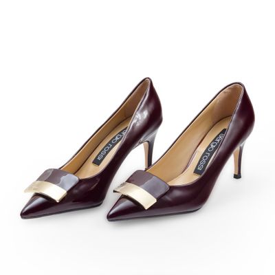 a pair of women ' s shoes with a bow on the heel