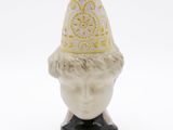 a small figurine of a man with a hat on his head