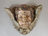 a sculpture of a man ' s head on a wall