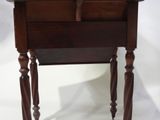 a small wooden table with a drawer on top of it