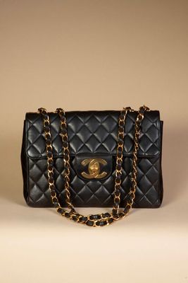a black chanel bag with a gold chain strap