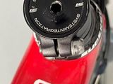 a close up of a red bike with a black handlebar