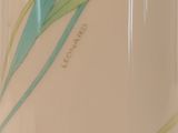 a close up of a vase with a flower on it