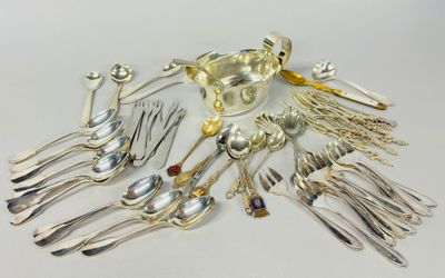 a lot of silver spoons and forks on the table