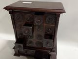 an image of a wooden cabinet with drawers on top of it