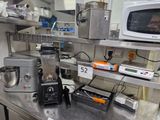 a kitchen with a microwave, blender, and other appliances on the counter
