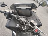 a close up of a motorcycle ' s handlebars with a monitor on it