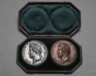 an image of a couple of coins in a case on a table