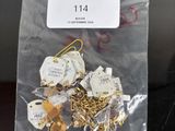 a bag of gold and silver paper clips on a table