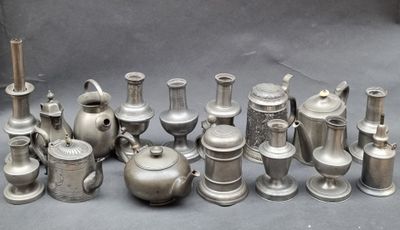 a lot of silver vases that are sitting on a table