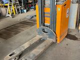 a forklift that is sitting in a warehouse