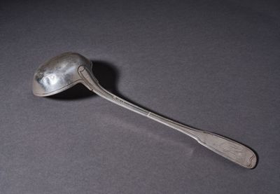 silver spoon with a spoon handle sitting on a table