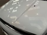 a white car parked in a parking lot next to a building