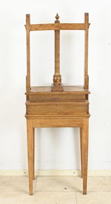 a wooden chair that has a wooden seat on it