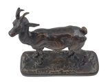 bronze sculpture of a goat on a base on a white background