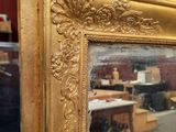 a mirror that is sitting on a table in a room