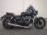 a picture of a black motorcycle parked in a garage
