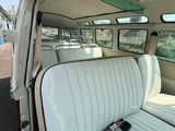 une photo d'une camionnette blanche avec une planche de surf sur la banquette arrière