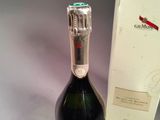a bottle of champagne next to a box of wine