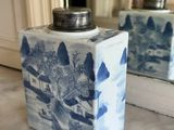 two blue and white vases sitting on a marble counter top