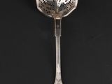 a close up of a spoon on a black surface with a black background